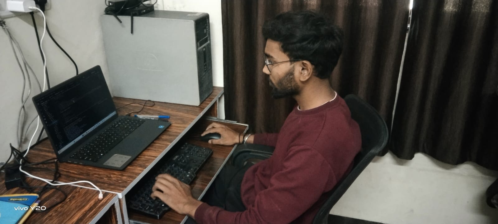 Computer science student working at desk during internship